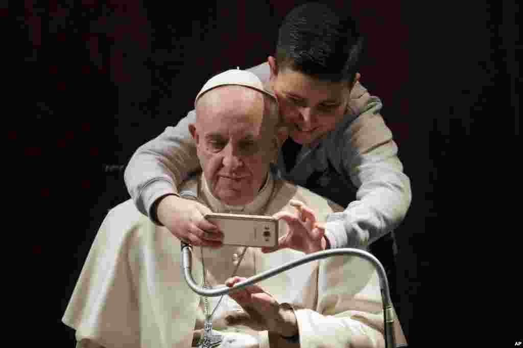 A boy takes a selfie with Pope Francis, during a visit to the parish of Santa Maria Josefa del Cuore di Gesu', in Rome, Sunday, Feb. 19, 2017. 