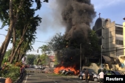 Motorcycles burn following a blast at the Pentecost Church Central Surabaya (GPPS), in Surabaya, East Java, Indonesia May 13, 2018, in this photo provided by Antara Foto.