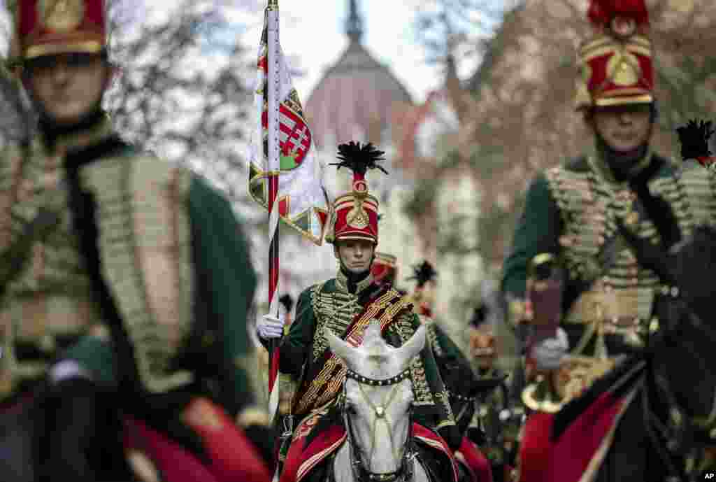 Hussars attend a ceremony during the 171th anniversary celebrations of the outbreak of the 1848 revolution and war of independence against the Habsburg rule in Budapest, Hungary.