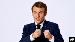FILE - French President Emmanuel Macron gestures as he delivers a speech during a press conference on France assuming EU presidency, Dec. 9, 2021 in Paris.