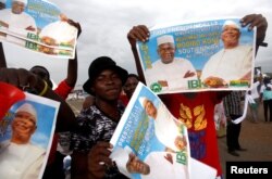 Supporters of Ibrahim Boubacar Keita, president of Mali and candidate for Rally for Mali party, carry his pictures during a rally in Bamako, ahead of the second round of the country's presidential election, in Mali, Aug. 10, 2018.