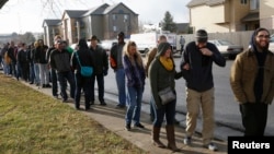 FILE - People wait in line to be among the first to legally buy recreational marijuana at the Botana Care store in Northglenn, Colorado, Jan. 1, 2014.