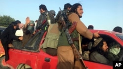 FILE - Taliban fighters ride in their vehicle in Surkhroad district of Nangarhar province, east of Kabul, Afghanistan, June 16, 2018. 