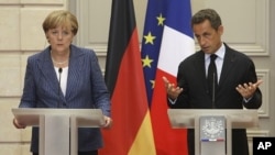 German Chancellor Angela Merkel, left, and France's President Nicolas Sarkozy during their joint press conference at the Elysee Palace, August 16, 2011