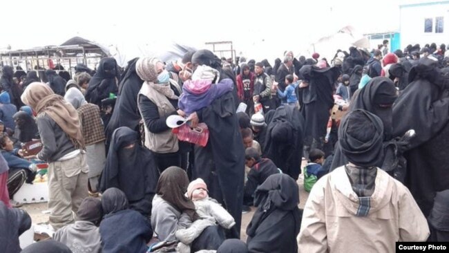 Women and children arrive at a reception area at al-Hol camp in northeast Syria, March 14, 2019. (Photo courtesy of International Rescue Committee)