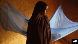 In this picture taken July 18, 2012, Zali Idy, 12, poses in her bedroom in the remote village of Hawkantaki, Niger. Zali was married in 2011. 