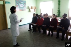 A nurse explains details about COVID 19 and ways to prevent contracting it at the Phyongchon District People's Hospital, April 1, 2020, in Pyongyang, North Korea.