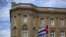 FILE - The Cuban national flag is seen raised over their embassy in Washington, July 20, 2015. 