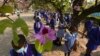 Schoolchildren wait to enter their school in Harare, Zimbabwe, Monday Sept, 28, 2020. Zimbabwe schools have reopened in phases, but with smaller number of pupils, more teachers and other related measures to enable children to resume their education withou