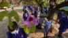 FILE: Schoolchildren wait to enter their school in Harare, Zimbabwe, Monday Sept, 28, 2020. Zimbabwe schools have reopened in phases, but with smaller number of pupils, more teachers and other related measures to enable children to resume their education withou