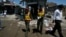 Rescue workers and journalists are seen outside the election campaign office of candidate Nasir Khan Afridi that was damaged in a bomb blast in Peshawar April 28 , 2013. 