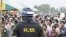 A Cambodian military policeman stands watch during the ground breaking ceremony of a Chinese funded road at Koun Damrey village, Banteay Meanchey province, about 15 kilometers (9 miles) east of Cambodia's border with Thailand, February 15, 2011