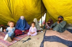Internally displaced Afghans who fled their home due to fighting between the Taliban and Afghan security personnel, are seen at a camp in Daman district of Kandahar province south of Kabul, Afghanistan, Aug. 5, 2021.