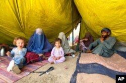 Internally displaced Afghans who fled their home due to fighting between the Taliban and Afghan security personnel, are seen at a camp in Daman district of Kandahar province south of Kabul, Afghanistan, Aug. 5, 2021.