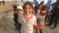 Little girls here in Khazir Camp, Kurdish Iraq say they like to pretend camp workers are giving them papers to get supplies like food and fuel on Dec. 1, 2016. (H.Murdock/VOA)