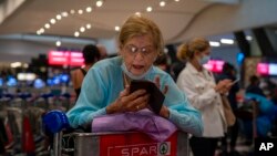 People line up to get on an Air France flight to Paris at OR Tambo's airport in Johannesburg, South Africa, Nov. 26, 2021. 