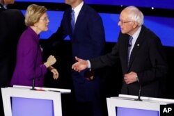 Democratic presidential candidates Sen. Elizabeth Warren and Sen. Bernie Sanders on Jan. 14, 2020, after a Democratic presidential primary debate in Des Moines, Iowa.
