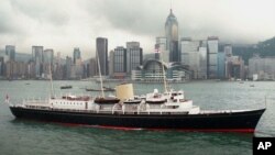 FILE - A June 23, 1997, photo shows the Royal Yacht Britannia passing the Hong Kong Convention Center in Hong Kong Harbor. 