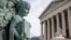 FILE - A cherub holding an open book adorns a flagpole on the plaza of the Supreme Court in Washington, April 4, 2016. 