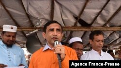 FILE - Mohib Ullah, a leader for the Rohingya community, addresses a gathering at the Kutupalong refugee camp in Ukhia on Aug. 25, 2019.