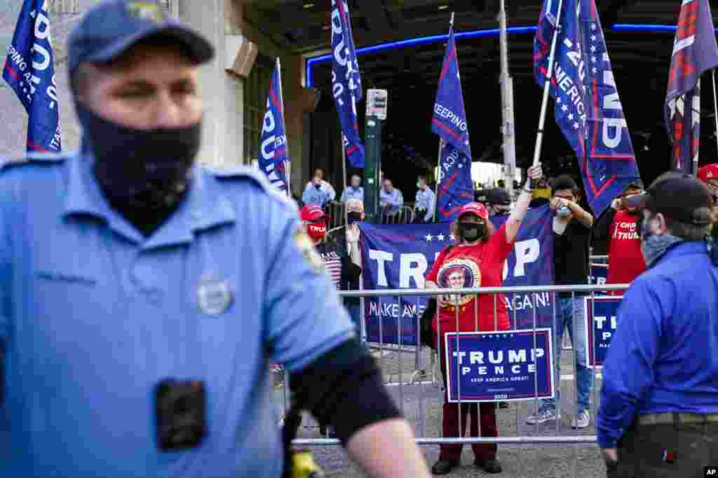 Police separate President Donald Trump supporters and pro-vote counting demonstrators three days after the presidential election polls closed, in Philadelphia, Pensylvania, Nov. 6, 2020.