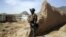An Afghan commando stands guard at the site of a suicide bomb attack on the outskirts of Kabul, Afghanistan, April 29, 2020. 