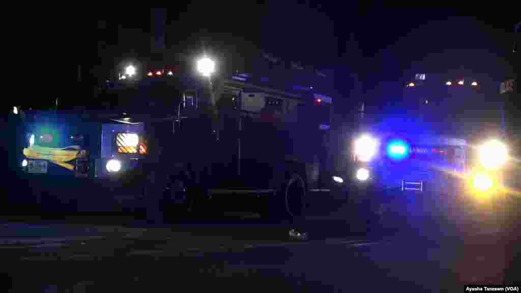 Officers in armored vehicles approach the Ferguson City Hall area where protesters were gathered, in Ferguson, Missouri, Nov. 25, 2014.