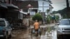 A man pushes bottles of clean water through the flooded areas in Chiang Rai, Thailand, Sept. 22, 2024.
