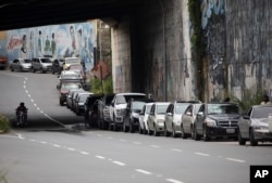 Vehicles line up near a gas station to fill their tanks in Caracas, Venezuela, Sept. 8, 2020.
