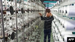 A worker works on a production line at a carpet factory in Lianyungang, in eastern China's Jiangsu province on Jan. 17, 2024.