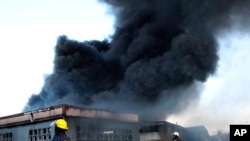 A factory burns on the outskirts of Durban, South Africa, July 14, 2021. Former president Jacob Zuma's incarceration for contempt of court, sparked off the worst violence South Africa has seen since the nation achieved democracy in 1994.