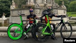 FILE - Ugandan cyclists Paul Lomuria and Lawrence Lorot pose for a photograph during the 2023 UCI Cycling World Championships in Glasgow, Scotland, Britain, August 7, 2023.