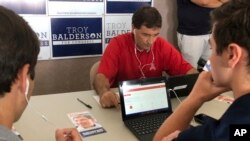 El republicano Troy Balderson, candidato al Congreso de EE.UU. por el décimo segundo distrito de Ohio, se une a voluntarios en un banco de datos telefónicos en Westerville, Ohio, el lunes, 6 de agosto de 2018.