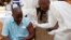 FILE - A health worker prepares to inject a man with an Ebola vaccine in Conakry, Guinea, March 7, 2015.