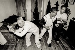 Elderly Cambodian men dance at an apartment building in Uptown, Chicago. (Stuart Isett)