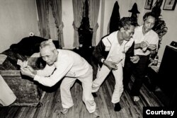 Elderly Cambodian men dance at an apartment building in Uptown, Chicago. (Stuart Isett)