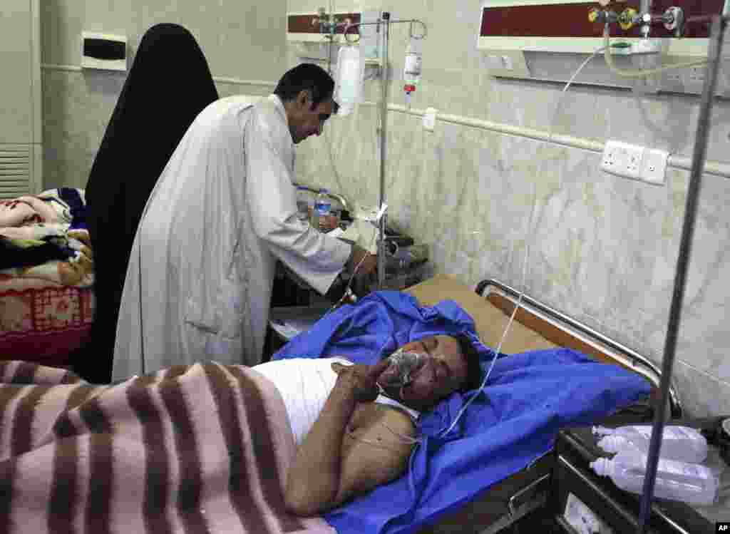 A man is treated at a hospital after a car bomb attack outside Kut, Iraq, June 16, 2013.