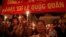 FILE - Protesters hold candles during a mass prayer for political dissident Le Quoc Quan at Thai Ha church in Hanoi June 30, 2013. 