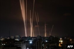 A salvo of rockets is fired by Palestinian militants from Gaza City toward Israel, Oct. 7, 2023.