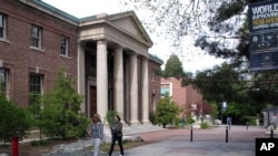 FILE - Students on the University of Nevada, Reno's walk past the Mackay School of Mines on the edge of the campus quad April 29, 2016 in Reno, Nevada