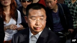 FILE - Human rights activist Jiang Tianyong speaks to journalists outside a hospital after his failed attempt to see blind Chinese activist Chen Guangcheng who is believed to be seeking treatment in Beijing, China, May 2, 2012. The wife of one of China's most prominent human rights campaigners says he has disappeared during a trip to visit relatives of a detained rights lawyer. 