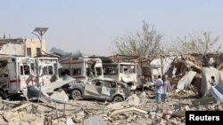 Damaged vehicles are seen at the site of a car bomb attack in Qalat, capital of Zabul province, Afghanistan, Sept. 19, 2019. 