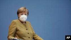 German Chancellor Angela Merkel arrives at a press conference in Berlin, Jan. 21, 2021.