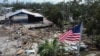 An American flag flies over the destroyed city hall in the aftermath of Hurricane Helene, in Horseshoe Beach, Florida, Sept. 28, 2024. 