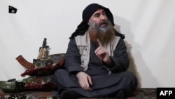 The chief of the Islamic State group, Abu Bakr al-Baghdadi, purportedly appears for the first time in five years in a propaganda video in an undisclosed location, in this undated TV grab taken from video released April 29 by Al-Furqan media. 