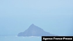 A handout photo taken on Jan. 18, 2022, and released Jan. 21 by New Zealand Defence Public Affairs shows an aerial view of Hunga Tonga-Hunga Ha’apai volcano following the eruption from the undersea volcano Jan. 15. 