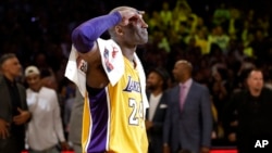 Los Angeles Lakers' Kobe Bryant solutes as he acknowledges fans after the last NBA basketball game of his career, against the Utah Jazz on Wednesday, April 13, 2016.
