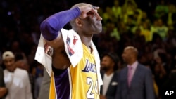 Los Angeles Lakers' Kobe Bryant solutes as he acknowledges fans after the last NBA basketball game of his career, against the Utah Jazz on Wednesday, April 13, 2016.