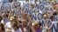 Civil servants hold up placards as they protest against government austerity measures in Madrid, July 23, 2012.