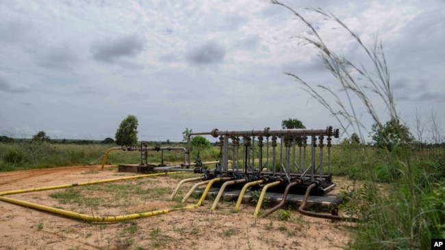 Pipes extend from an oil drilling structure near the village of Kinkazi, outside Moanda, Democratic Republic of the Congo, Sunday, Dec. 24, 2023. (AP Photo/Mosa'ab Elshamy)